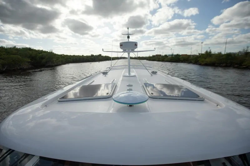Slide: The Image of 2026 Hylas M49 yacht cruising on a serene river under a cloudy sky. - 5
