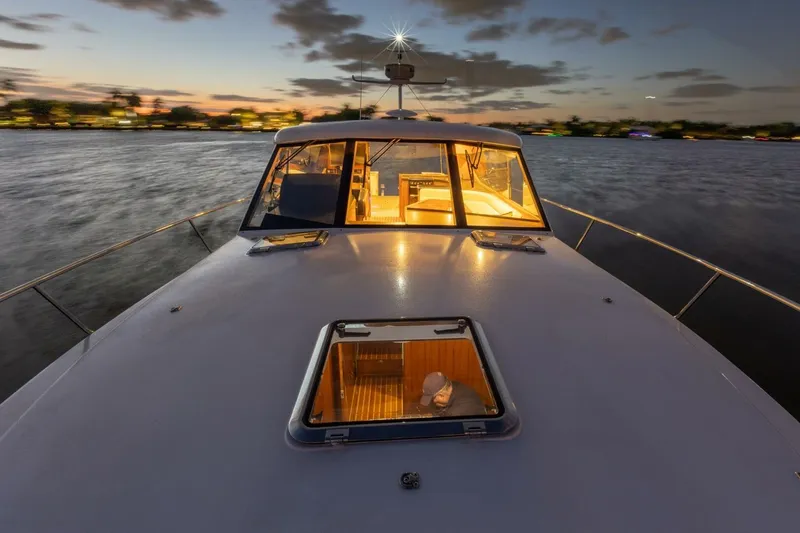 Slide: The Image of 2026 Hylas M49 yacht at sunset, illuminated interior, calm waters, scenic view. - 8