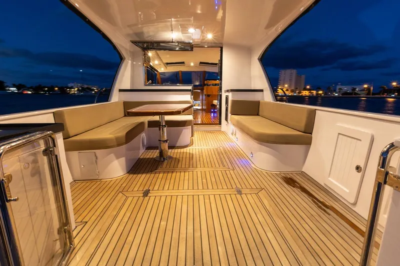 Slide: The Image of Luxurious 2026 Hylas M49 yacht interior with elegant seating and ambient lighting at dusk. - 9