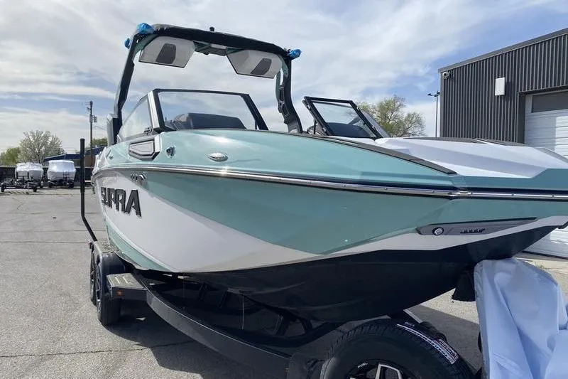 Slide: The Image of 2025 Supra SV 575 boat in a parking lot, showcasing sleek design and modern features. - 2