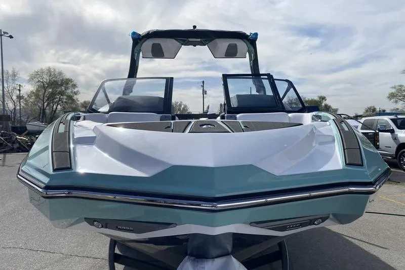 Slide: The Image of 2025 Supra SV 575 boat, sleek design, parked outdoors under cloudy sky. - 3