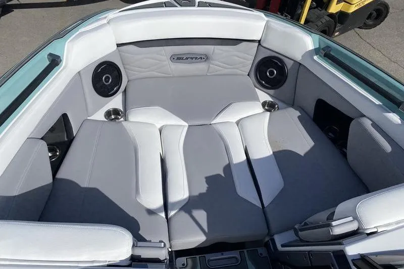 Slide: The Image of 2025 Supra SV 575 boat interior with gray seating and built-in speakers. - 7