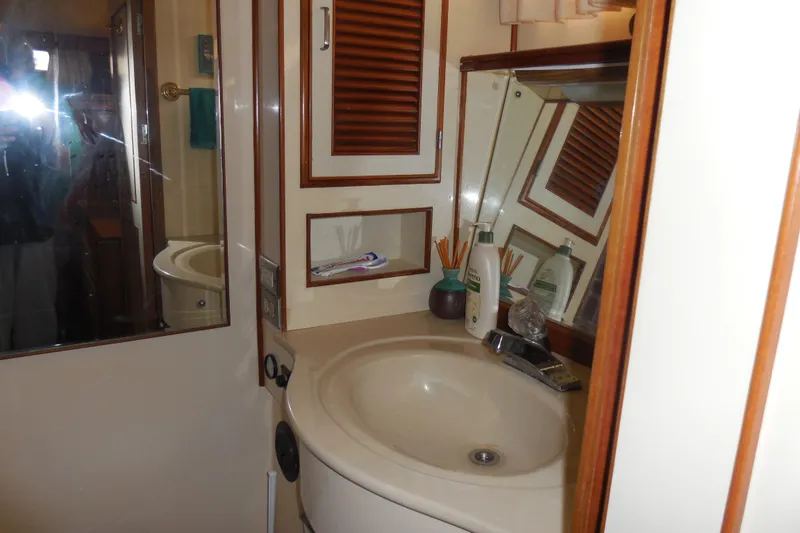 Slide: The Image of 1987 Hi-Star Sundeck bathroom with sink, mirror, and toiletries. - 18