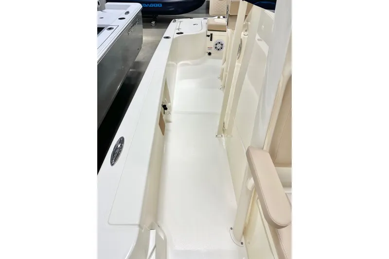 Slide: The Image of 2026 Scout 231 XSB boat interior with beige seating and white deck. - 14
