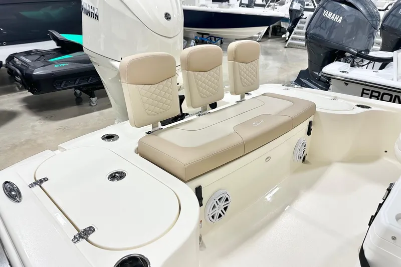 Slide: The Image of 2026 Scout 231 XSB boat interior with beige seating and Yamaha engine. - 15