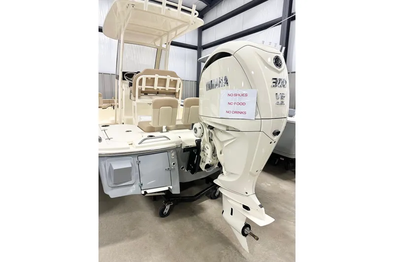 Slide: The Image of 2026 Scout 231 XSB boat with Yamaha engine, indoor display, no shoes, food, or drinks allowed. - 18