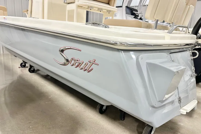 Slide: The Image of 2026 Scout 231 XSB boat, sleek design, displayed indoors on a showroom floor. - 19