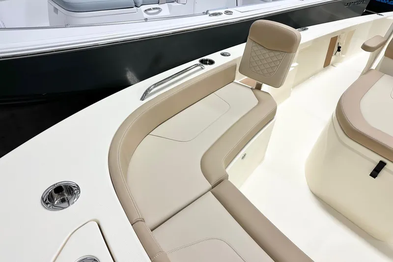 Slide: The Image of 2026 Scout 231 XSB boat interior with beige seating and stainless steel accents. - 9