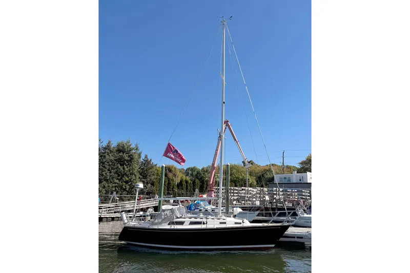 The Image of 1989 Sabre 30 MKIII sailboat docked at marina under clear blue sky. - 0
