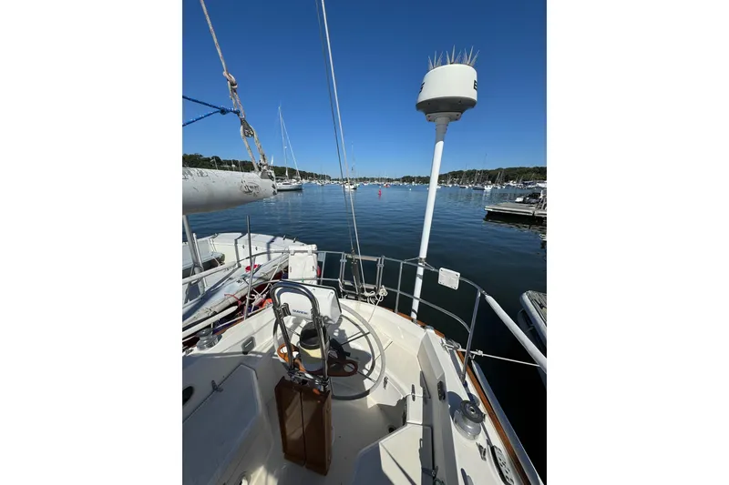 Slide: The Image of Sailboat Sabre 30 MKIII, 1989 model, docked in a serene marina under clear blue skies. - 10