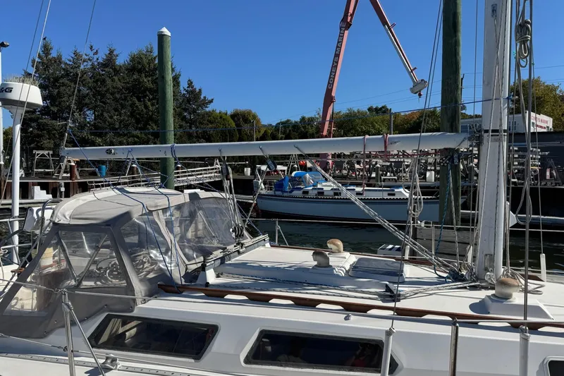 Slide: The Image of 1989 Sabre 30 MKIII sailboat docked at a marina under clear blue skies. - 13