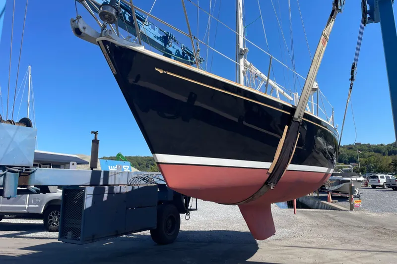 Slide: The Image of 1989 Sabre 30 MKIII sailboat being lifted by a crane in a boatyard. - 19