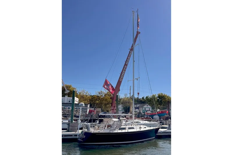 Slide: The Image of 1989 Sabre 30 MKIII sailboat docked at a marina under clear blue skies. - 2