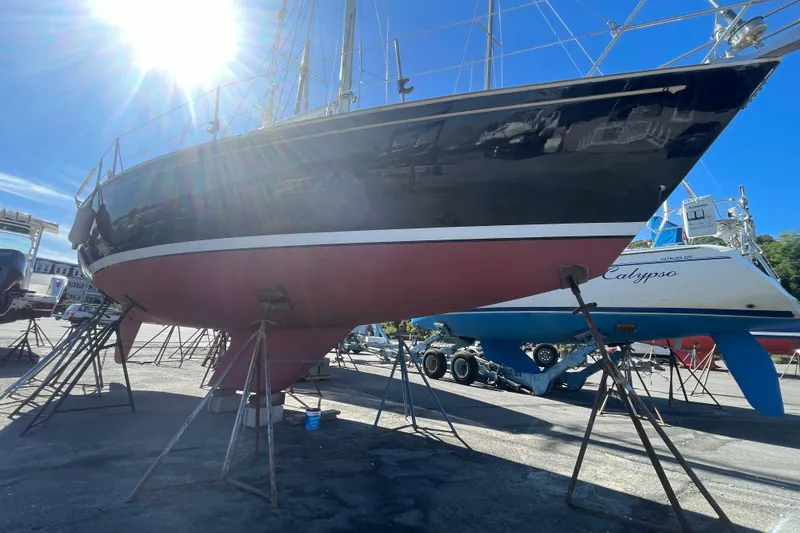 Slide: The Image of 1989 Sabre 30 MKIII sailboat on stands, sunlit, in a boatyard. - 22