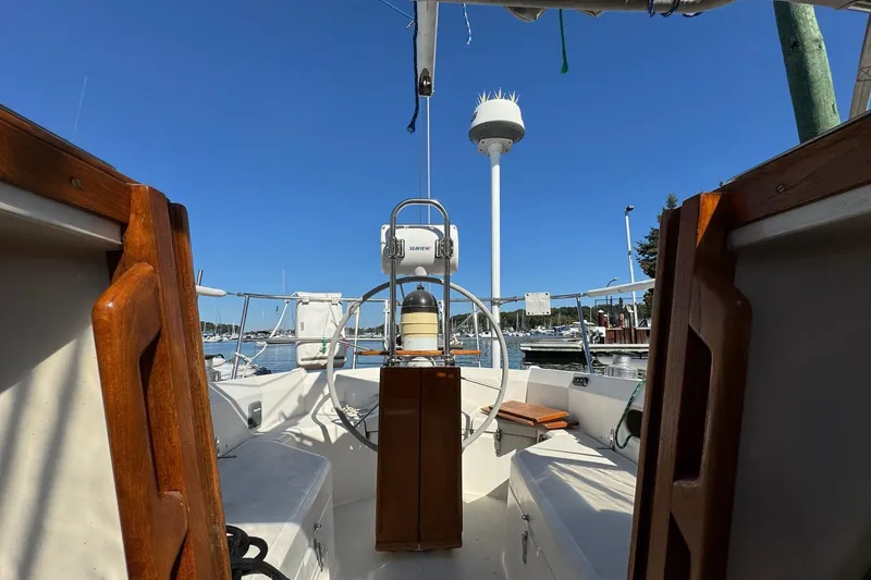 Slide: The Image of Cockpit view of 1989 Sabre 30 MKIII sailboat with wooden accents and marina backdrop. - 26