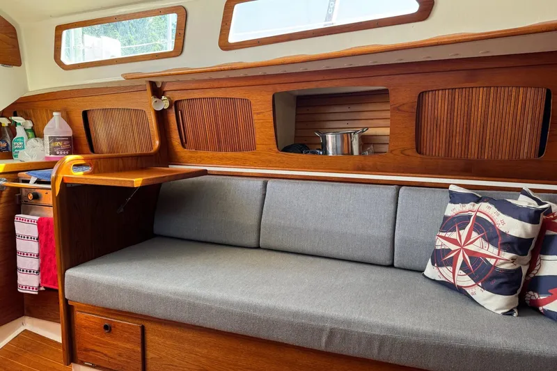 Slide: The Image of Interior of 1989 Sabre 30 MKIII sailboat with wooden finish and gray seating. - 31