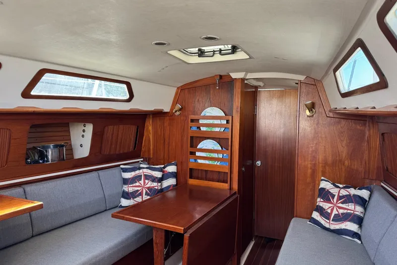 Slide: The Image of Interior of 1989 Sabre 30 MKIII sailboat with wooden finish and nautical-themed cushions. - 37