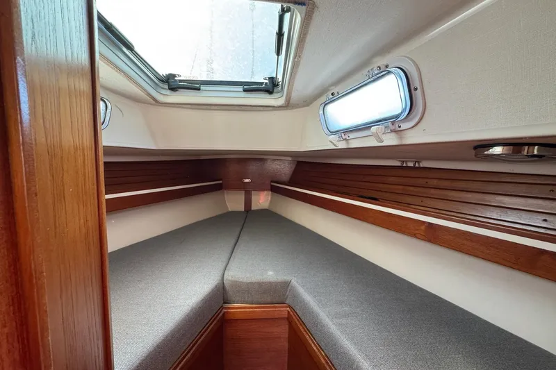 Slide: The Image of 1989 Sabre 30 MKIII sailboat interior with cozy V-berth and wooden accents. - 41