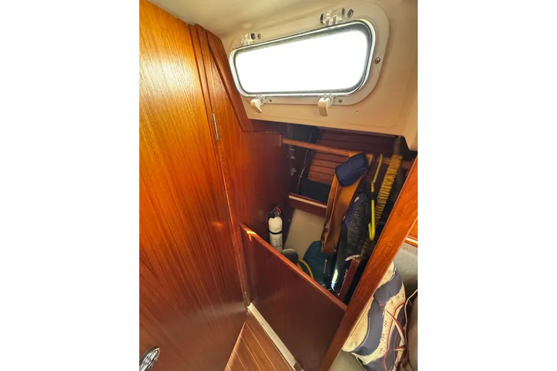Slide: The Image of Interior of 1989 Sabre 30 MKIII sailboat with wooden cabinetry and storage space. - 44