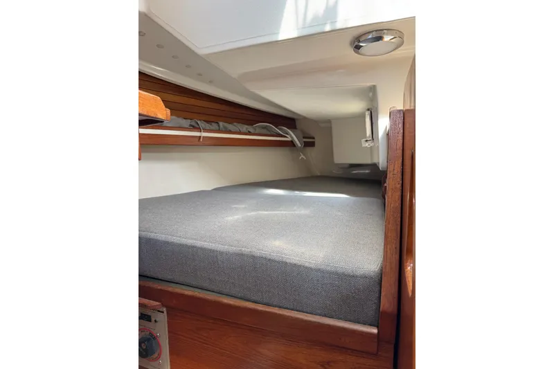 Slide: The Image of Interior cabin of 1989 Sabre 30 MKIII sailboat with gray cushions and wooden accents. - 47