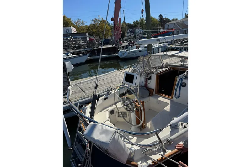 Slide: The Image of 1989 Sabre 30 MKIII sailboat cockpit with steering wheel, docked at marina. - 5
