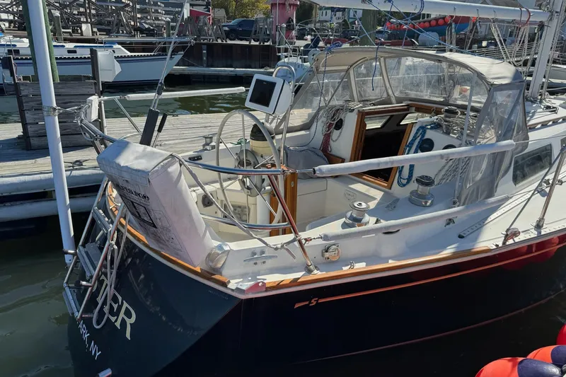 Slide: The Image of 1989 Sabre 30 MKIII sailboat docked at marina, featuring cockpit and navigation equipment. - 6
