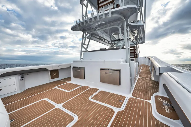Slide: The Image of 2022 Yellowfin 54 Offshore boat deck with sleek design and ocean backdrop. - 12