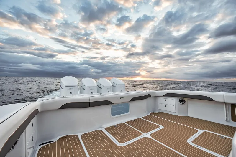 Slide: The Image of 2022 Yellowfin 54 Offshore boat at sea, sunset view, spacious deck, powerful engines. - 16