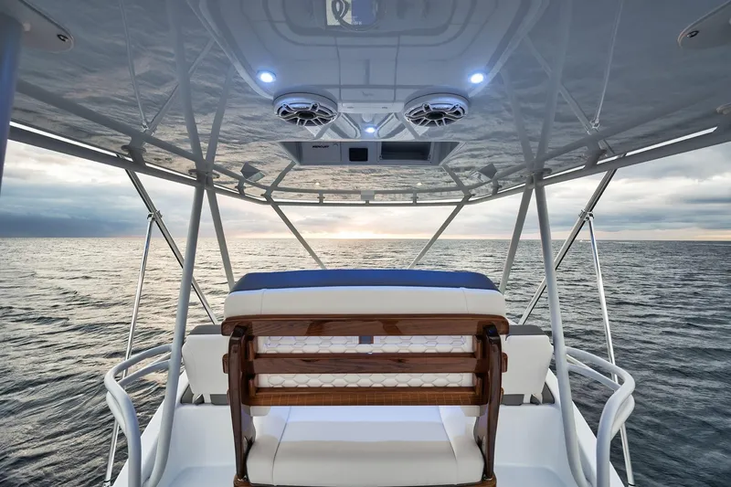 Slide: The Image of 2022 Yellowfin 54 Offshore boat interior with ocean view at sunset. - 18