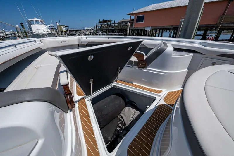 Slide: The Image of 2022 Yellowfin 54 Offshore boat with open storage compartment, docked at marina. - 23