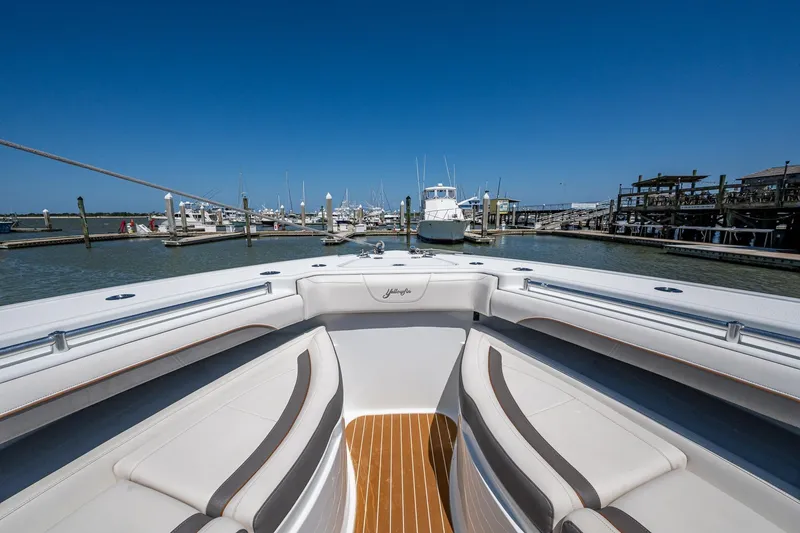 Slide: The Image of 2022 Yellowfin 54 Offshore boat docked at marina under clear blue sky. - 26