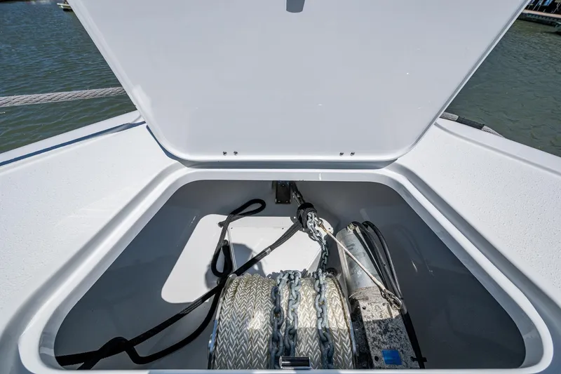 Slide: The Image of Anchor storage compartment on 2022 Yellowfin 54 Offshore boat, open lid, showing anchor and rope. - 28