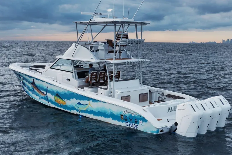 Slide: The Image of 2022 Yellowfin 54 Offshore boat with vibrant marine artwork, cruising on open water. - 3