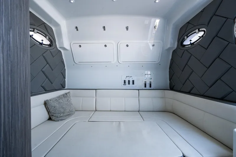Slide: The Image of 2022 Yellowfin 54 Offshore cabin interior with plush seating and modern design. - 37