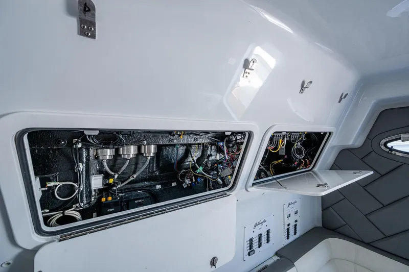 Slide: The Image of Interior view of 2022 Yellowfin 54 Offshore boat's electrical and wiring compartments. - 38