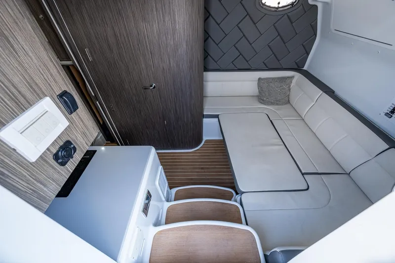 Slide: The Image of 2022 Yellowfin 54 Offshore interior with modern seating and wood accents. - 39
