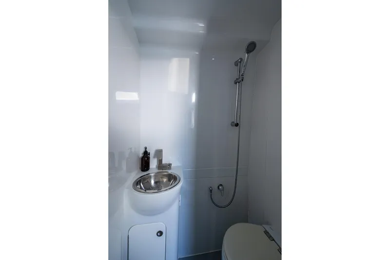 Slide: The Image of 2022 Yellowfin 54 Offshore bathroom with shower, sink, and modern fixtures. - 42