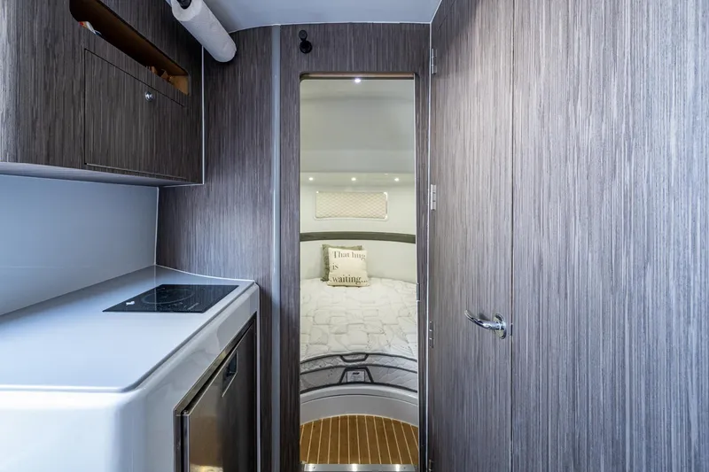 Slide: The Image of 2022 Yellowfin 54 Offshore interior with modern kitchen and cozy bedroom. - 45