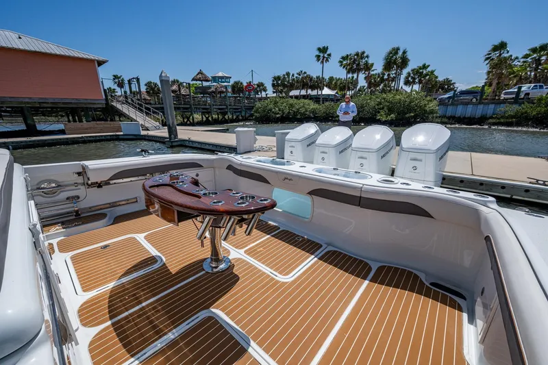 Slide: The Image of 2022 Yellowfin 54 Offshore boat with spacious deck and multiple outboard engines. - 47