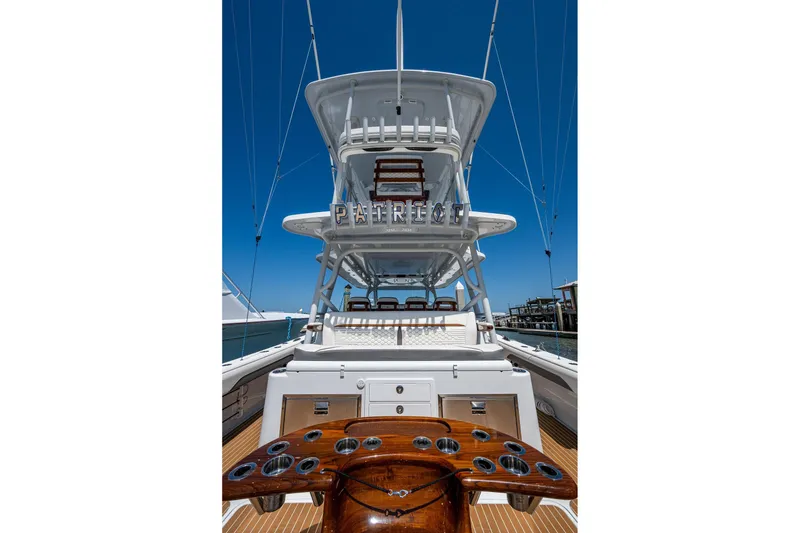 Slide: The Image of 2022 Yellowfin 54 Offshore boat with tower, docked under clear blue sky. - 50