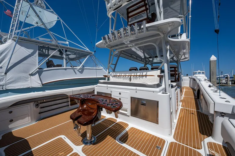 Slide: The Image of 2022 Yellowfin 54 Offshore boat with teak deck and fishing chair at marina. - 51