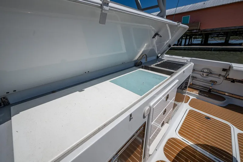 Slide: The Image of 2022 Yellowfin 54 Offshore boat with open storage compartment and teak flooring. - 52