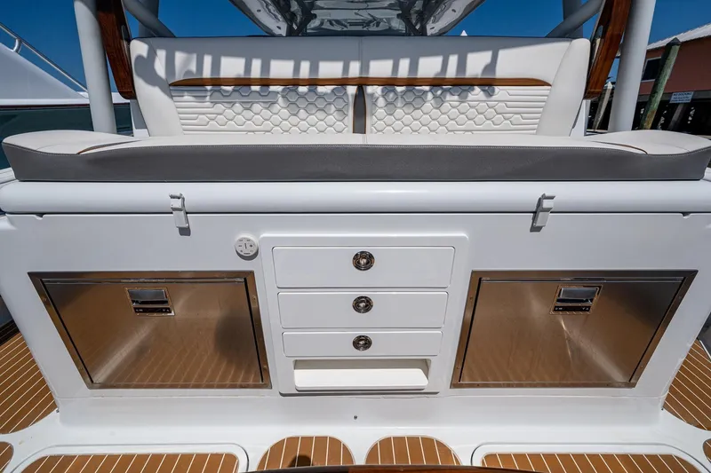 Slide: The Image of 2022 Yellowfin 54 Offshore boat interior with storage compartments and cushioned seating. - 53