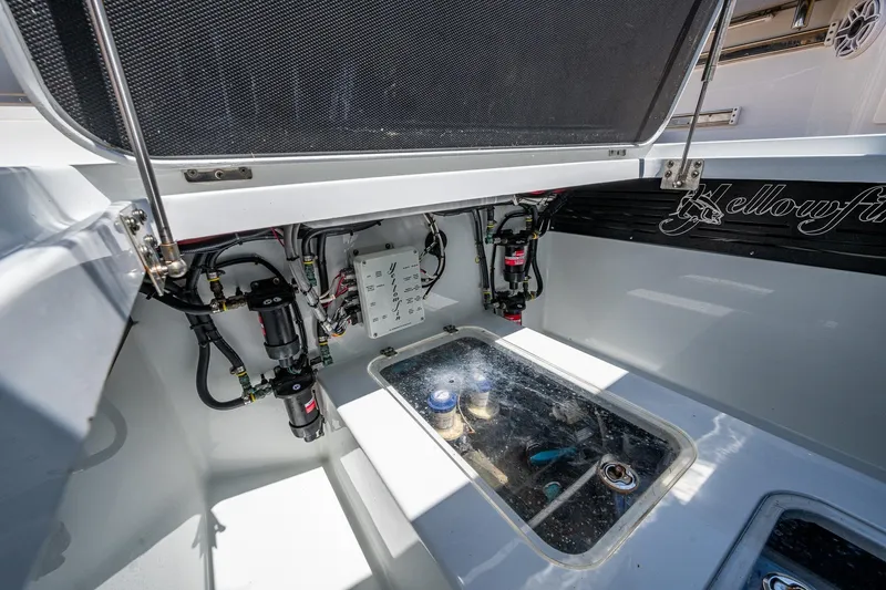 Slide: The Image of 2022 Yellowfin 54 Offshore boat interior with open hatch and visible wiring. - 55