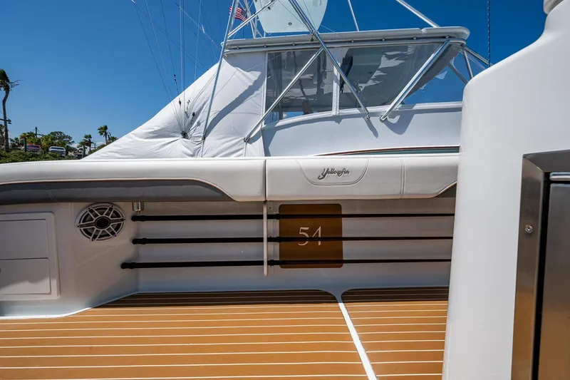 Slide: The Image of 2022 Yellowfin 54 Offshore boat deck with rod holders and sleek design. - 61