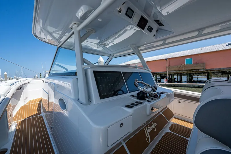 Slide: The Image of 2022 Yellowfin 54 Offshore boat interior with modern helm and seating. - 64