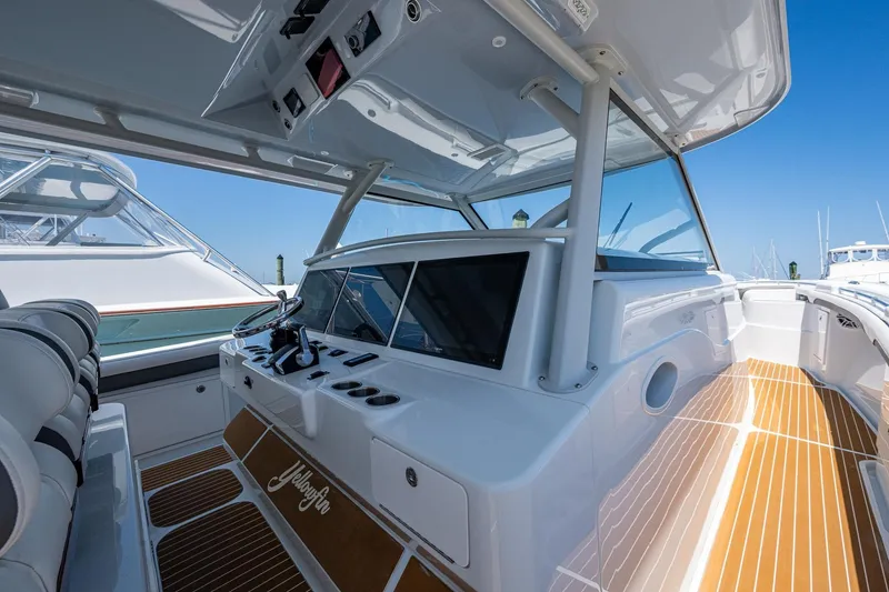 Slide: The Image of 2022 Yellowfin 54 Offshore boat interior with sleek design and modern controls. - 65