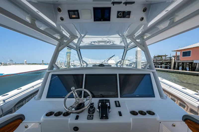 Slide: The Image of 2022 Yellowfin 54 Offshore boat helm with modern controls and navigation screens. - 66