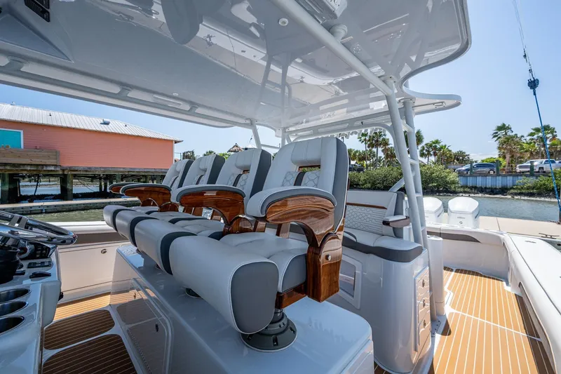 Slide: The Image of 2022 Yellowfin 54 Offshore boat interior with luxurious seating and helm station. - 69