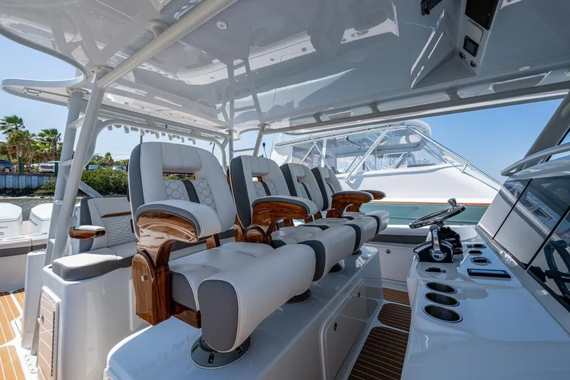 Slide: The Image of Luxurious helm seating on 2022 Yellowfin 54 Offshore boat, featuring sleek design and modern controls. - 71